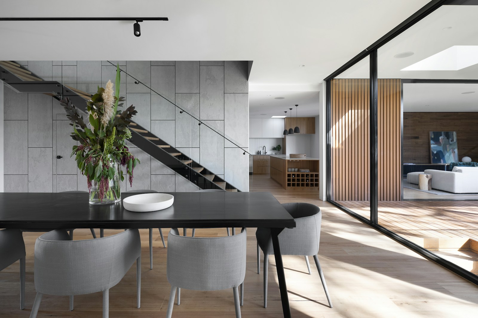 Representative contemporary dining interior with clean medium-brown plank flooring