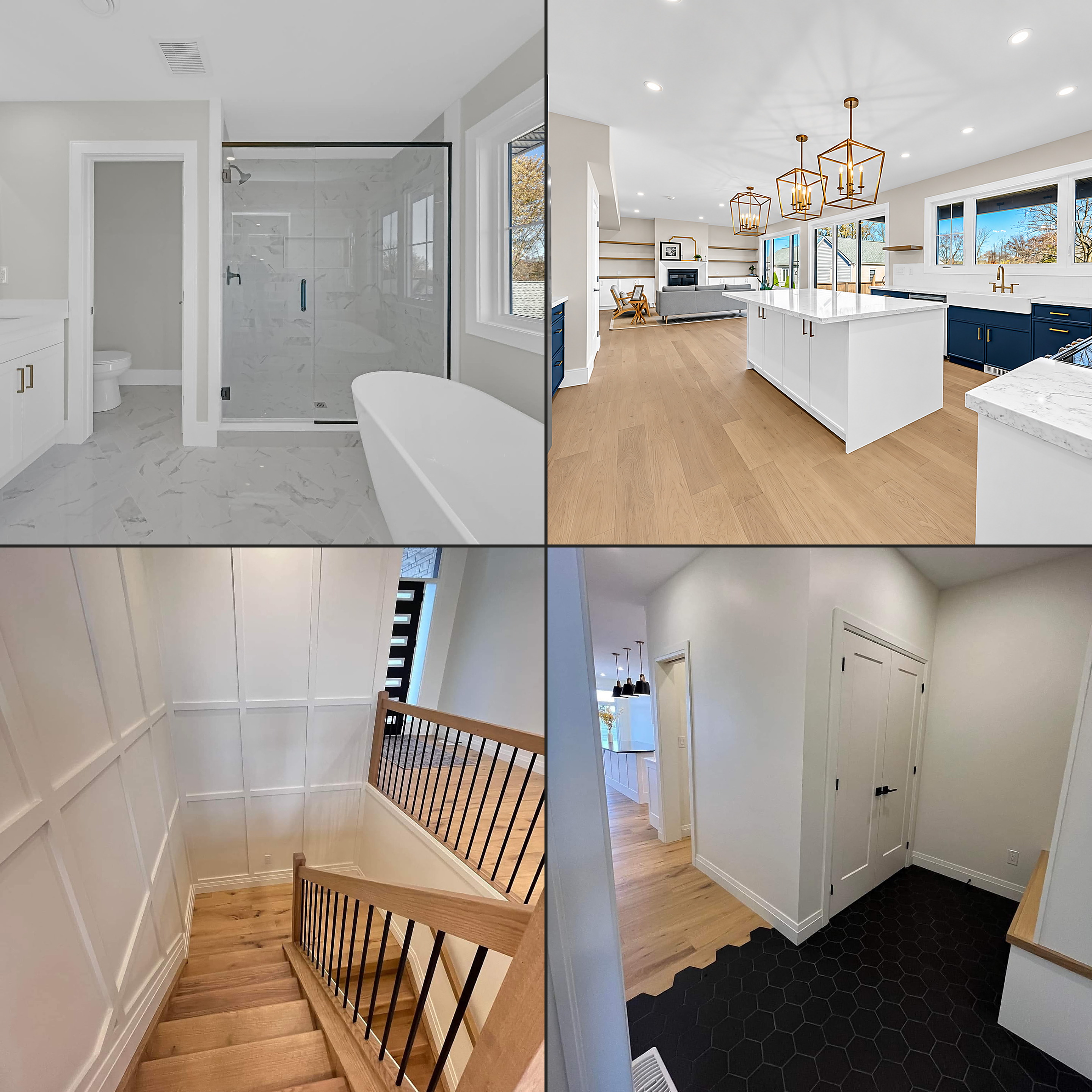 Construction interiors: a marble-tile bathroom with freestanding tub, a navy-and-white kitchen with gold pendants, an oak staircase with panelled walls, and a hexagonal-tile entryway