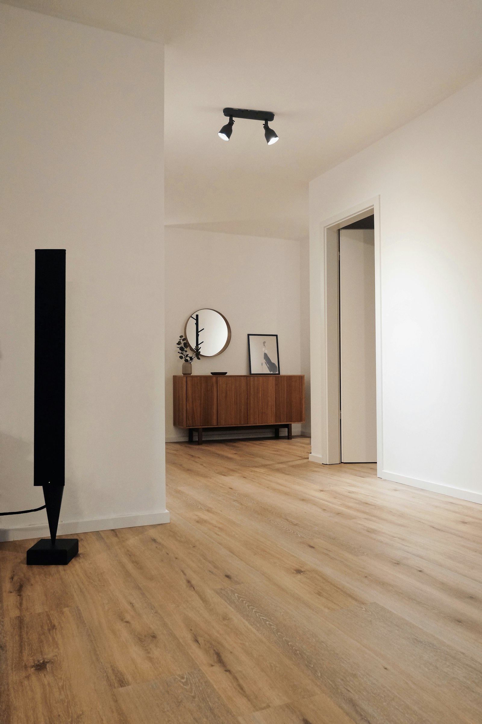 Representative minimalist interior with light natural oak-look plank flooring